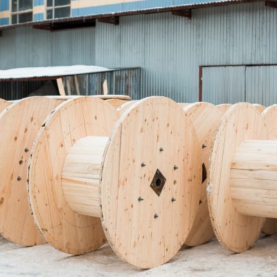 Wood processing plant Large empty wooden coils. The new cable drums at the industrial area. Outdoors